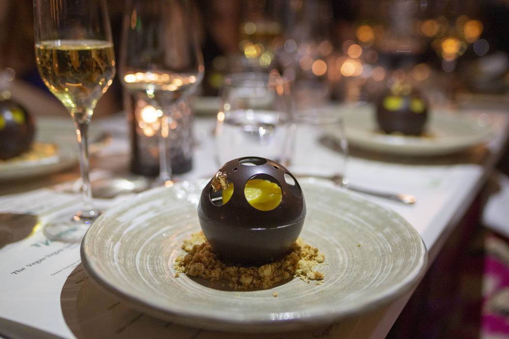 Chocolate Sphere with Coconut Mousse and Candied Pineapple as the final course for the recreati ...