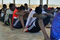 Rescued migrants rest near the city of Khoms, about 75 miles east of Tripoli, Libya., Tuesday, ...