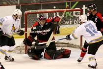 Las Vegas Wranglers goalie Mike McKenna, middle, makes the save in front of Phoenix Roadrunners ...