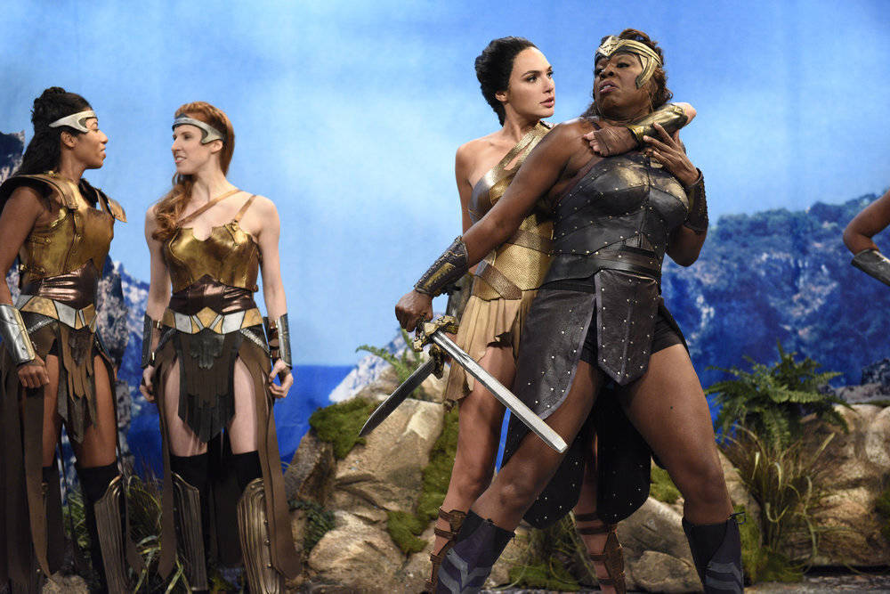 This image released by NBC shows Gal Gadot, center, and Leslie Jones, right during a sketch on ...