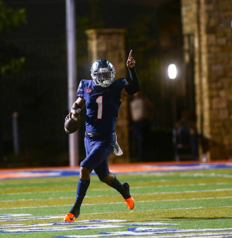 Bishop Gorman's Micah Bowens (1) motions to teammates during the first half of a football game ...