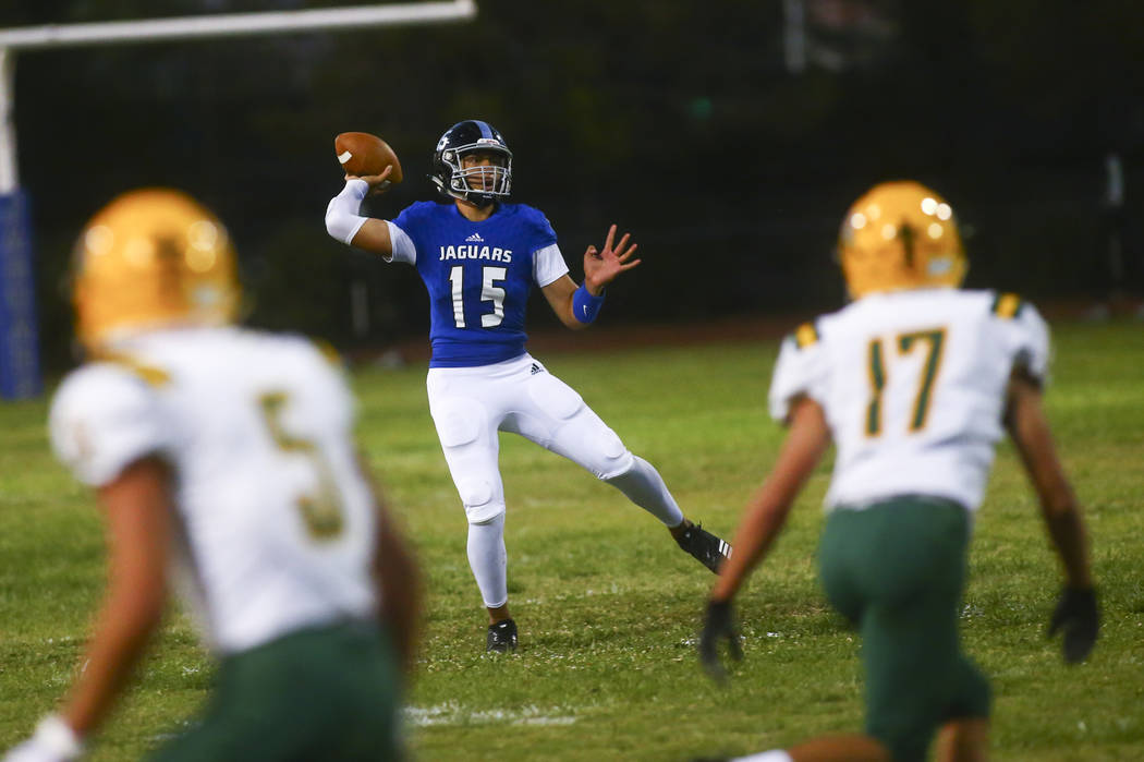 Desert Pines' Rjay Tagataese (15) looks to pass during the first half of a football game agains ...