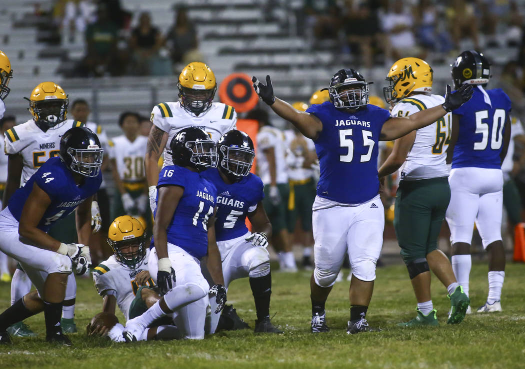 Desert Pines' Blaze Homalon (55) celebrates after sacking Bishop Manogue quarterback Drew Scola ...