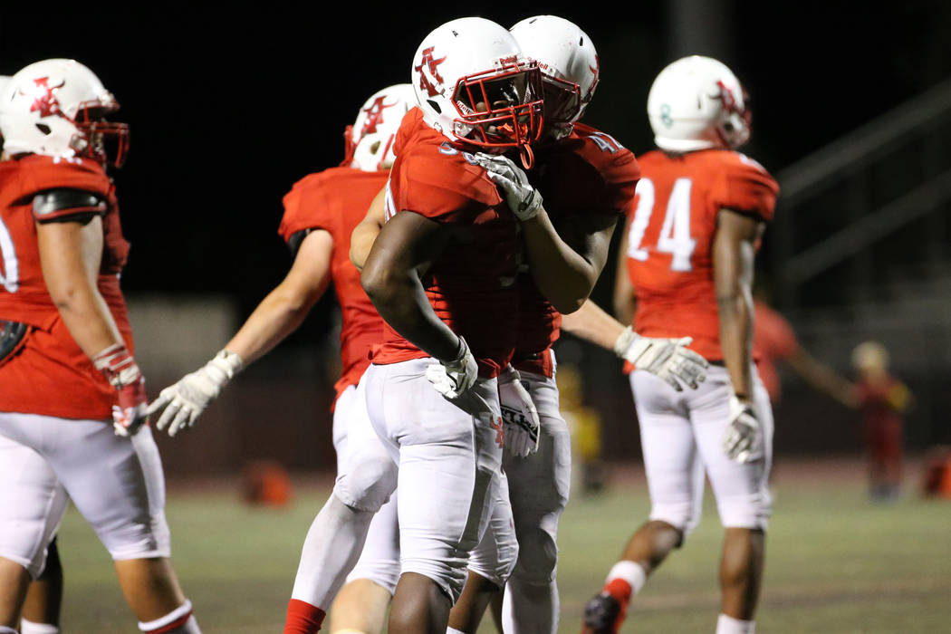 Arbor View's Darius Williams (30) is hugged by (42) Myles Alvarez after his winning touchdown i ...