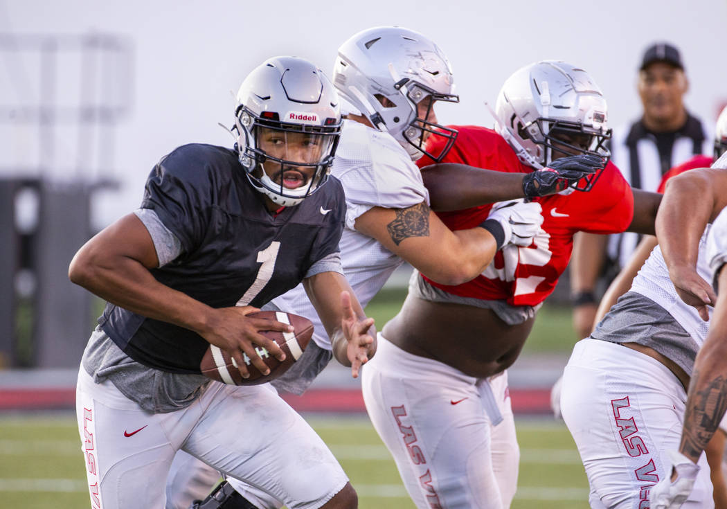 UNLV QB Armani Rogers (1) looks for room to run during their first major scrimmage of football ...