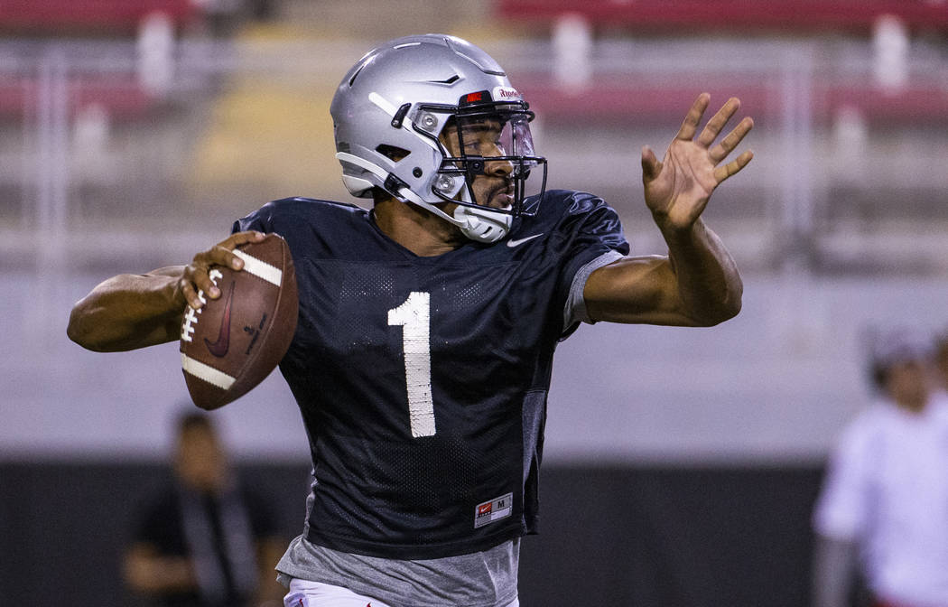 UNLV QB Armani Rogers (1) eyes an open receiver during their first major scrimmage of football ...