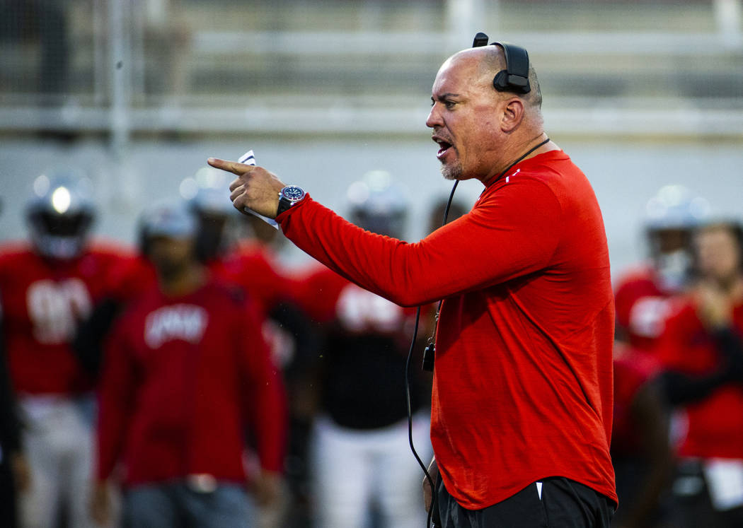 UNLV head coach Tony Sanchez yells a few instructions to his players during their first major s ...