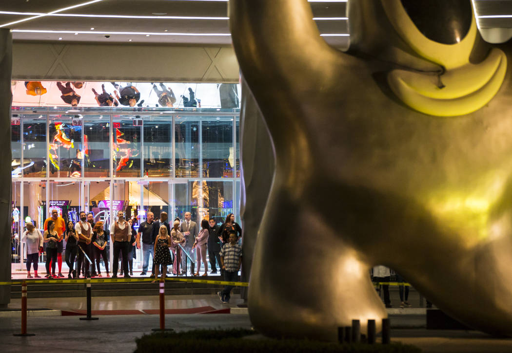 People watch before the "Sam by Starck" statue at the SLS Las Vegas is demolished ahead of the ...