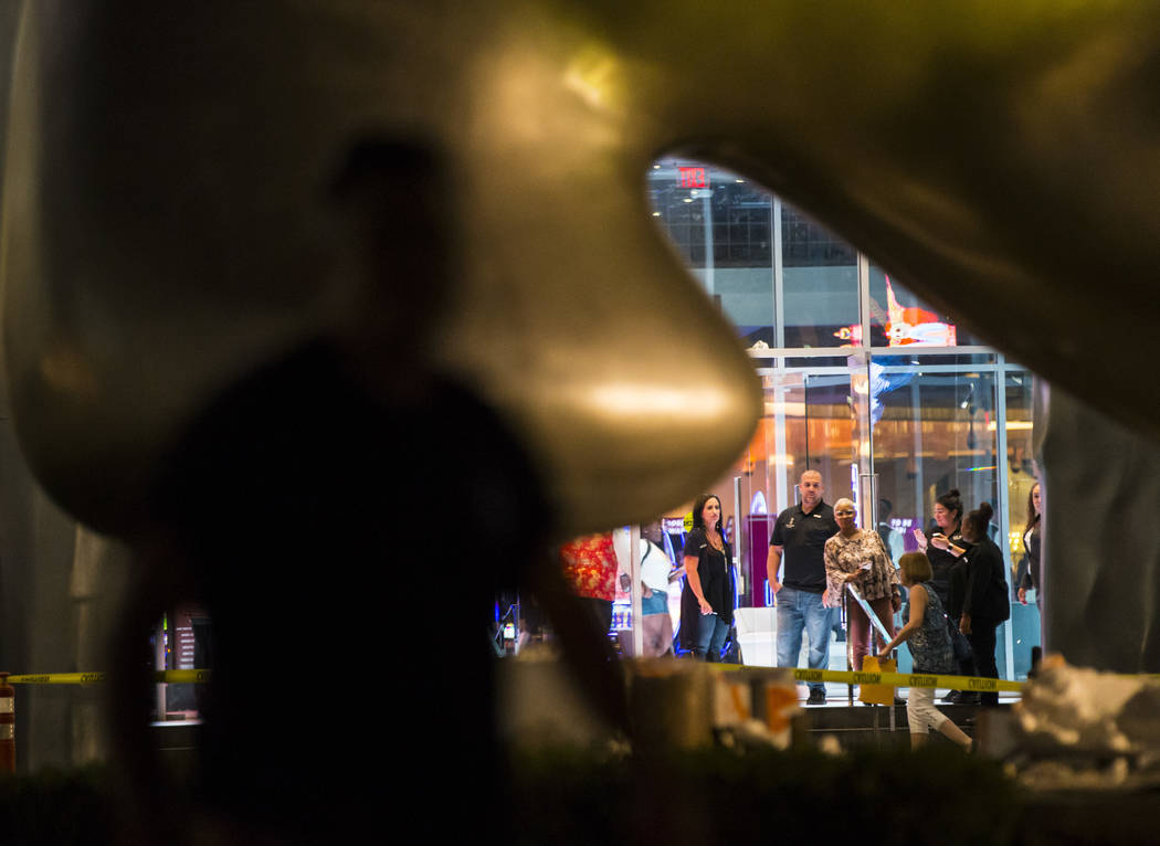 People watch as the "Sam by Starck" statue at the SLS Las Vegas is demolished ahead o ...