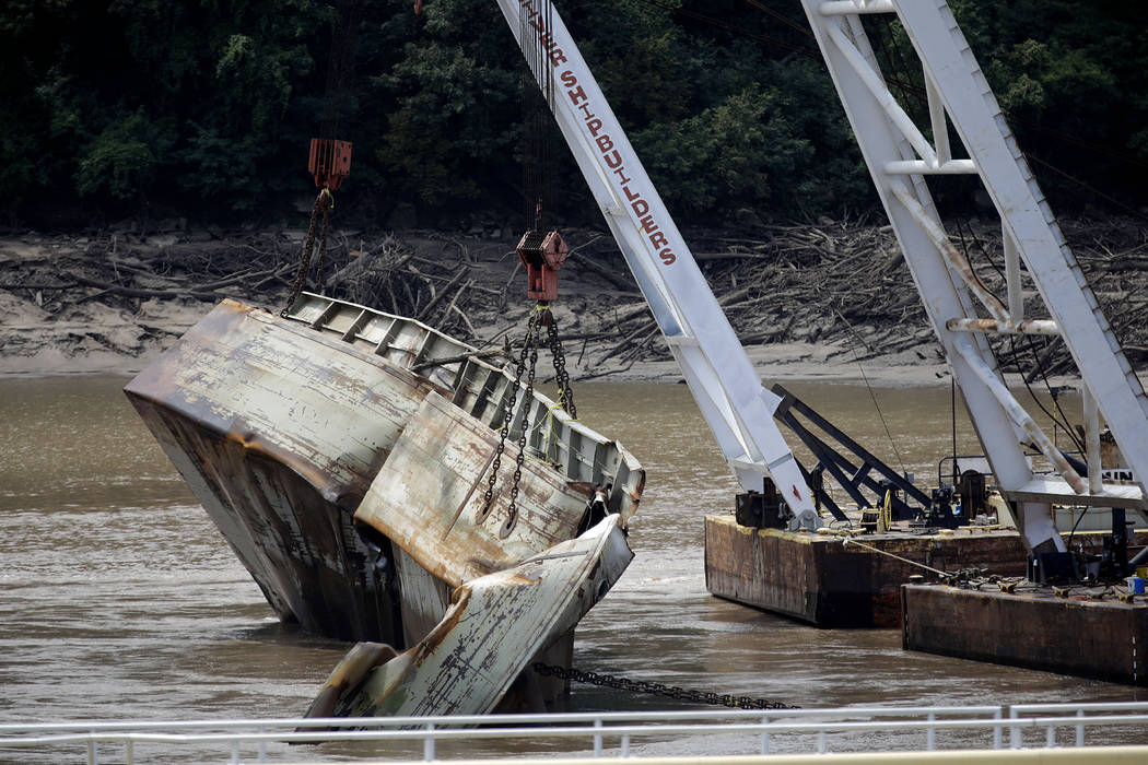 One of two sunken barges is removed from the Webbers Falls Lock and Dam 16 Tuesday, Aug. 27, 20 ...