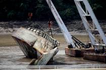 One of two sunken barges is removed from the Webbers Falls Lock and Dam 16 Tuesday, Aug. 27, 20 ...