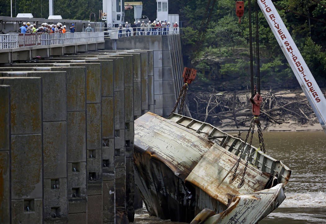 One of two sunken barges is removed from the Webbers Falls Lock and Dam 16 Tuesday, Aug. 27, 20 ...
