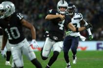 Oakland Raiders quarterback Derek Carr (4) runs with the football during the first half of an N ...