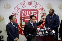 From left, attorney Daniel Deng, forensic scientist Henry Lee and attorney Brian Dunn hold a jo ...