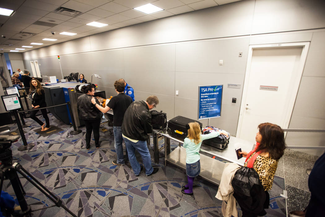 Passengers move through pre-check lane at the Terminal 3 TSA checkpoint at McCarran Internation ...