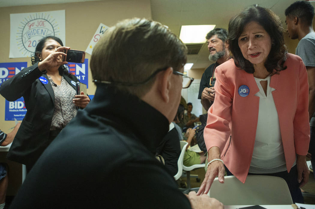 Former Labor Secretary Hilda Solis speaks with Joe Biden campaign volunteer Rick Carter, from H ...