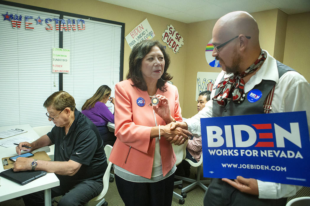 Former Labor Secretary Hilda Solis shakes hands with Joe Biden campaign staffer Gil Lopez at th ...