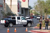 Police investigate an officer-involved shooting at a shopping complex near Blue Diamond Road an ...