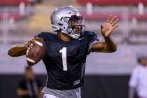 UNLV QB Armani Rogers (1) eyes an open receiver during their first major scrimmage of football ...