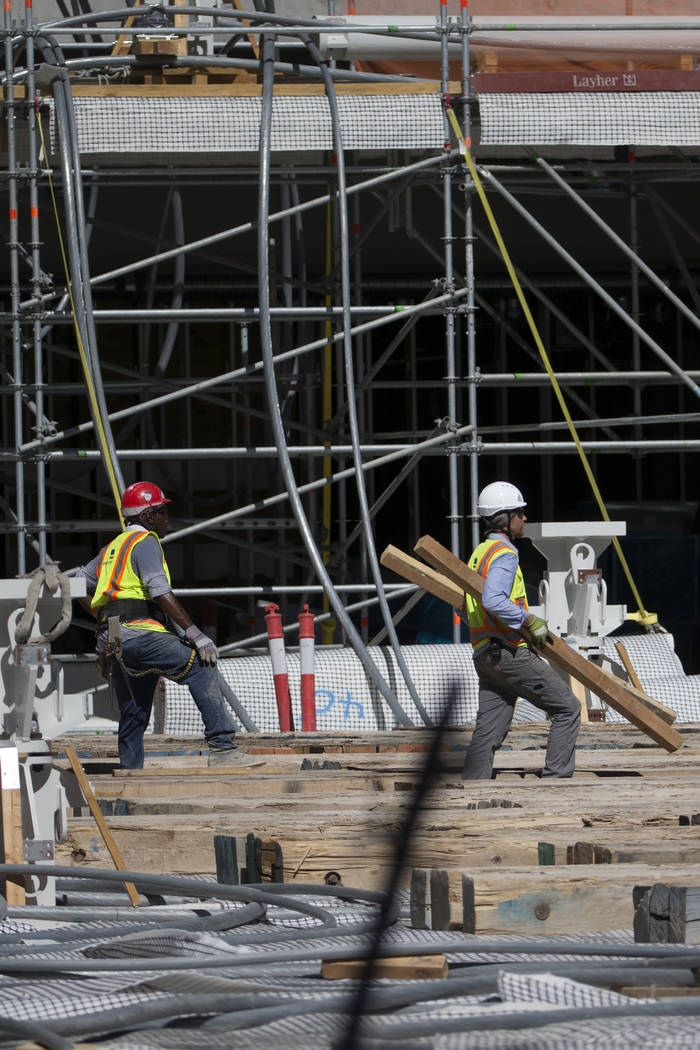 Workers walk on the floor level of the Raiders Allegiant Stadium construction site in Las Vegas ...
