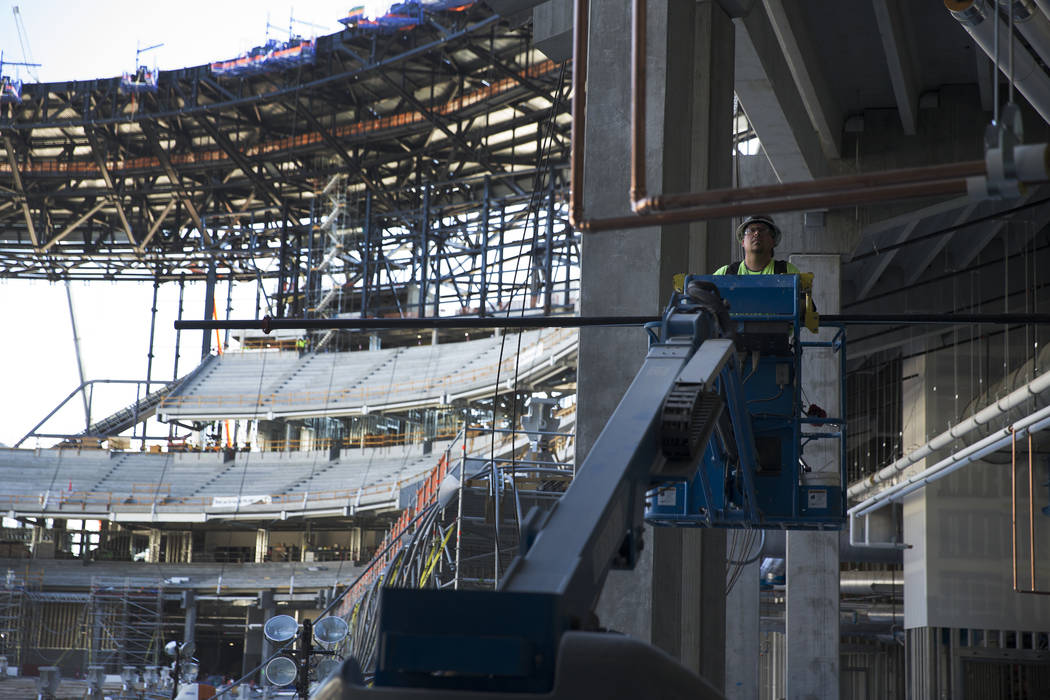 A laborer works at the Raiders stadium construction site in Las Vegas, Wednesday, Aug. 28, 2019 ...