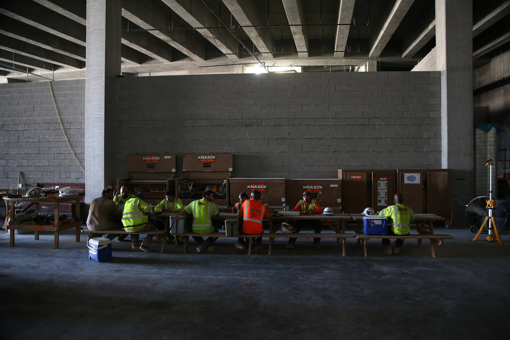 Workers sit for lunch at the Raiders Allegiant stadium construction site in Las Vegas, Wednesda ...