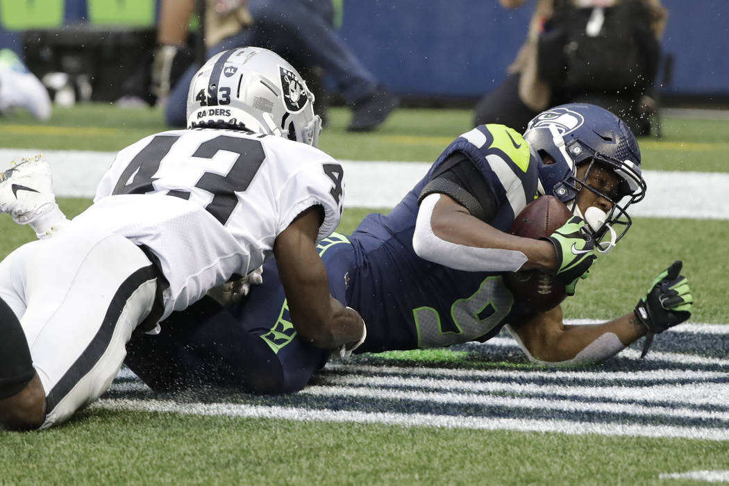 Seattle Seahawks wide receiver Terry Wright, right, comes down as Oakland Raiders cornerback Ma ...