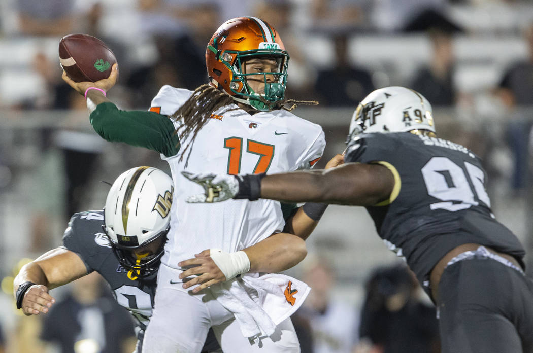 Florida A&M quarterback Rasean McKay (17) is hit by Central Florida defensive lineman Antho ...
