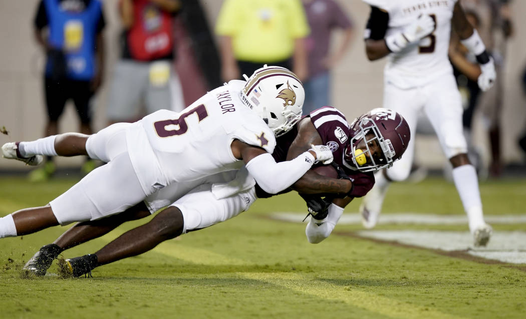 Texas A&M wide receiver Quartney Davis (1) dives over the goal line for a touchdown as Texa ...