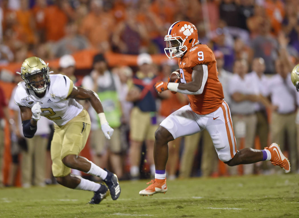 Clemson's Travis Etienne (9) out runs Georgia Tech's Tariq Carpenter to score a touchdown durin ...