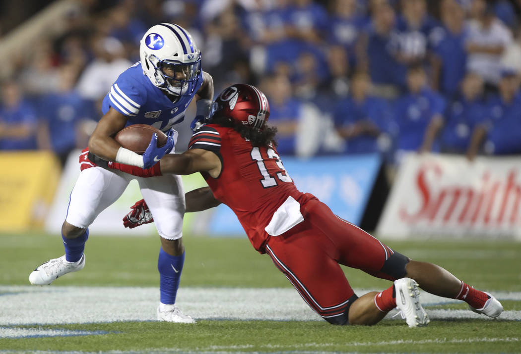 BYU wide receiver Aleva Hifo (15) is tackled by Utah linebacker Francis Bernard (13) during the ...