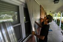 Richard Henson (foreground) and his uncle, Peter Henson, prepare their grandmother's house Thur ...