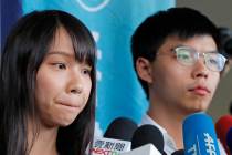 Pro-democracy activists Joshua Wong, right, and Agnes Chow speak to media outside a district co ...