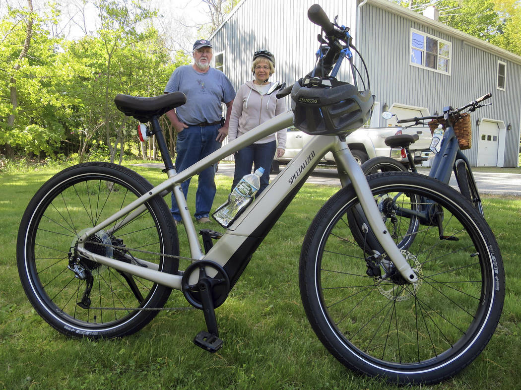 FILE-In this June 8, 2019 file photo, Gordon and Janice Goodwin show their electric-assist bicy ...