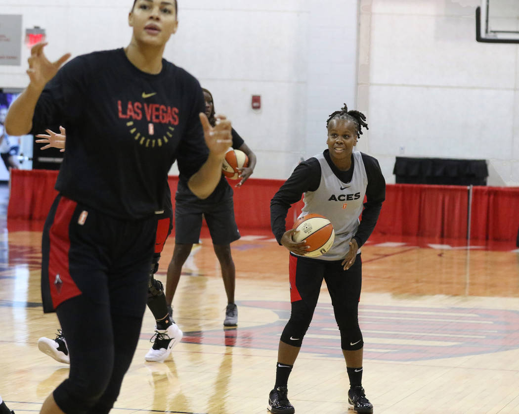 Las Vegas Aces' guard Epiphanny Prince, right, prepares to shoot the ball during team practice ...