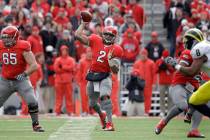 Ohio State quarterback Terrelle Pryor (2) passes with help blocking from offensive linesman Ju ...