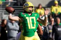 In this Dec. 31, 2018, file photo, Oregon quarterback Justin Herbert throws a pass during the f ...