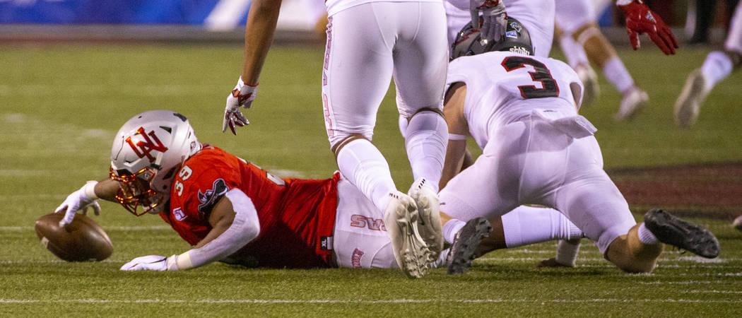 UNLV Rebels fullback Daniel Godfrey (39) reaches out to secure a fumble by Southern Utah Thunde ...