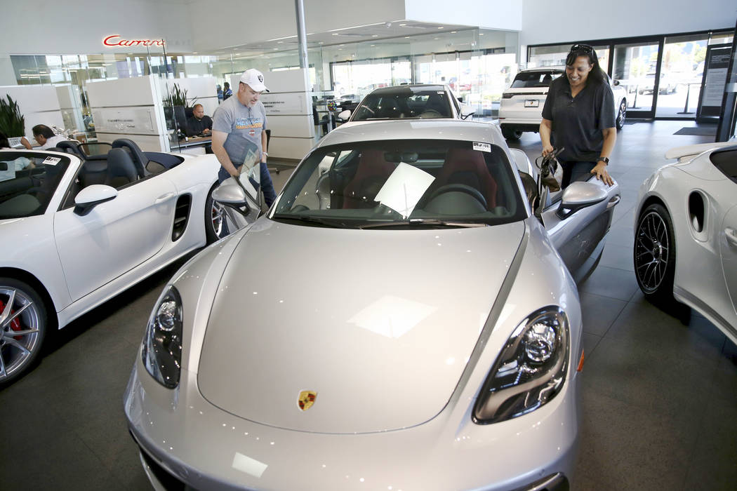 Stefanie and Ian Coffee of Las Vegas check out a 718 Cayman GTS Porsche at Gaudin Porsche in La ...