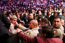 Las Vegas police and security try to stop Dillon Danis, who serves as McGregor's jiu-jitsu coac ...