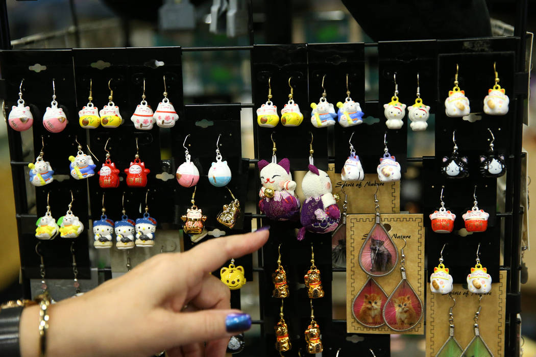 Cat themed earrings for sale by Paws and Pals during The International Cat Association’s ...