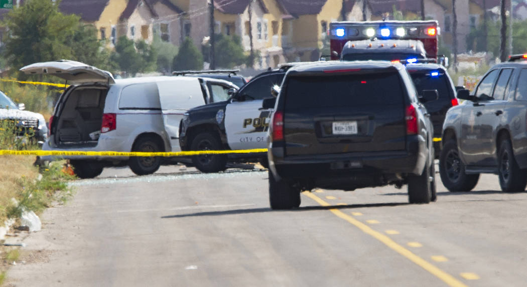 Odessa and Midland police and sheriff's deputies surround a white van in Odessa, Texas, Saturda ...