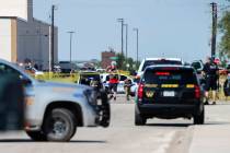 Odessa and Midland police and sheriff's deputies surround the area behind Cinergy in Odessa, Te ...