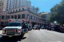 Fire crews gather on Market Street outside the Hotel Fairmont in downtown San Jose, Calif., aft ...