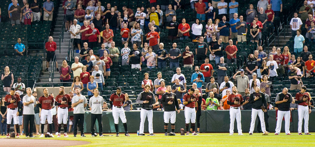 Members of the Arizona Diamondbacks stand for the national anthem before playing the Philadelph ...