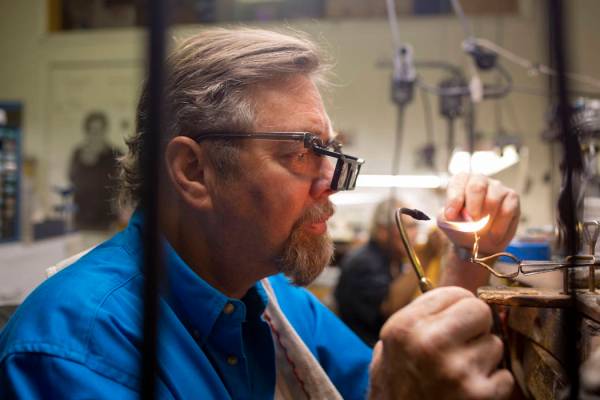 Gold Casters Jewelry owner Michael Holland prepares a wedding ring to be set in his workshop at ...