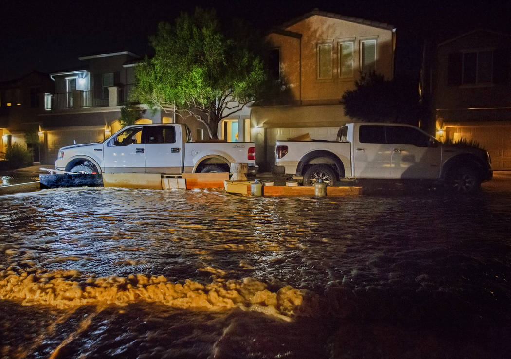 Southwest valley residents try to redirect floodwaters with their trucks and wooden boards at t ...