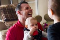 Michael Russell plays with his great-niece Ava Gonzales, 11 months old, at his home in Las Vega ...