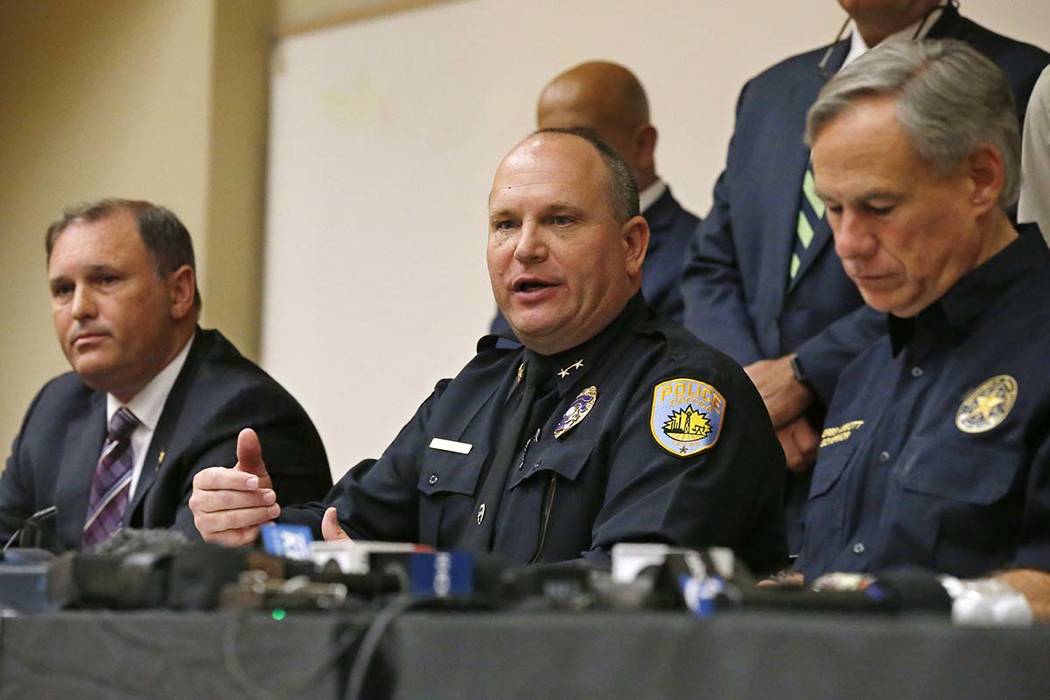 Odessa Police Chief Michael Gerke, center, answers a question concerning Saturday's shooting du ...