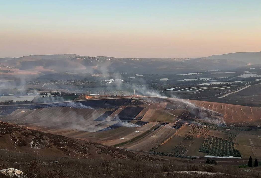 Smoke rises from Israeli army shells that landed in the southern Lebanese border village of Mar ...